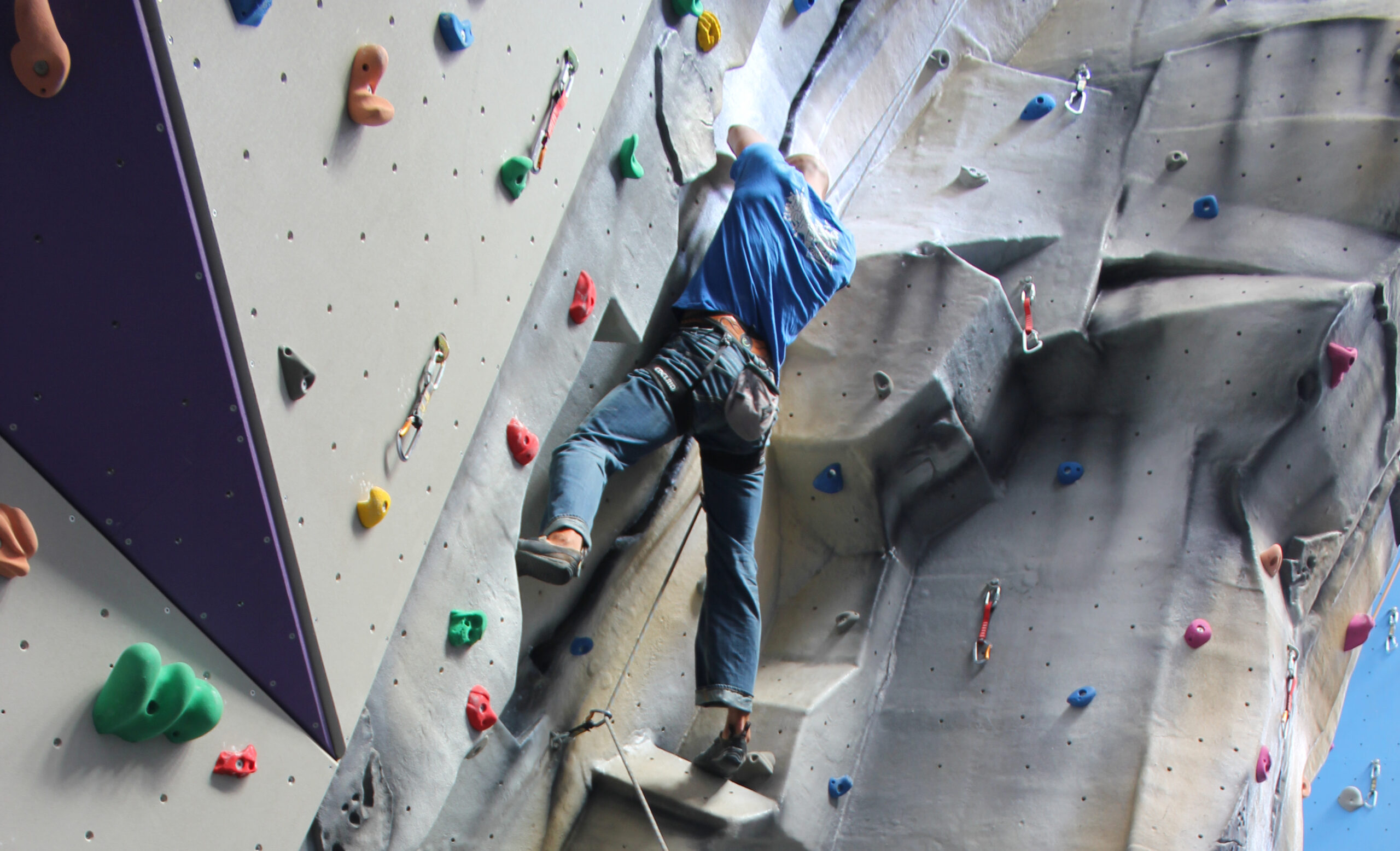 Man Climbing Up Indoor Climbing Walls