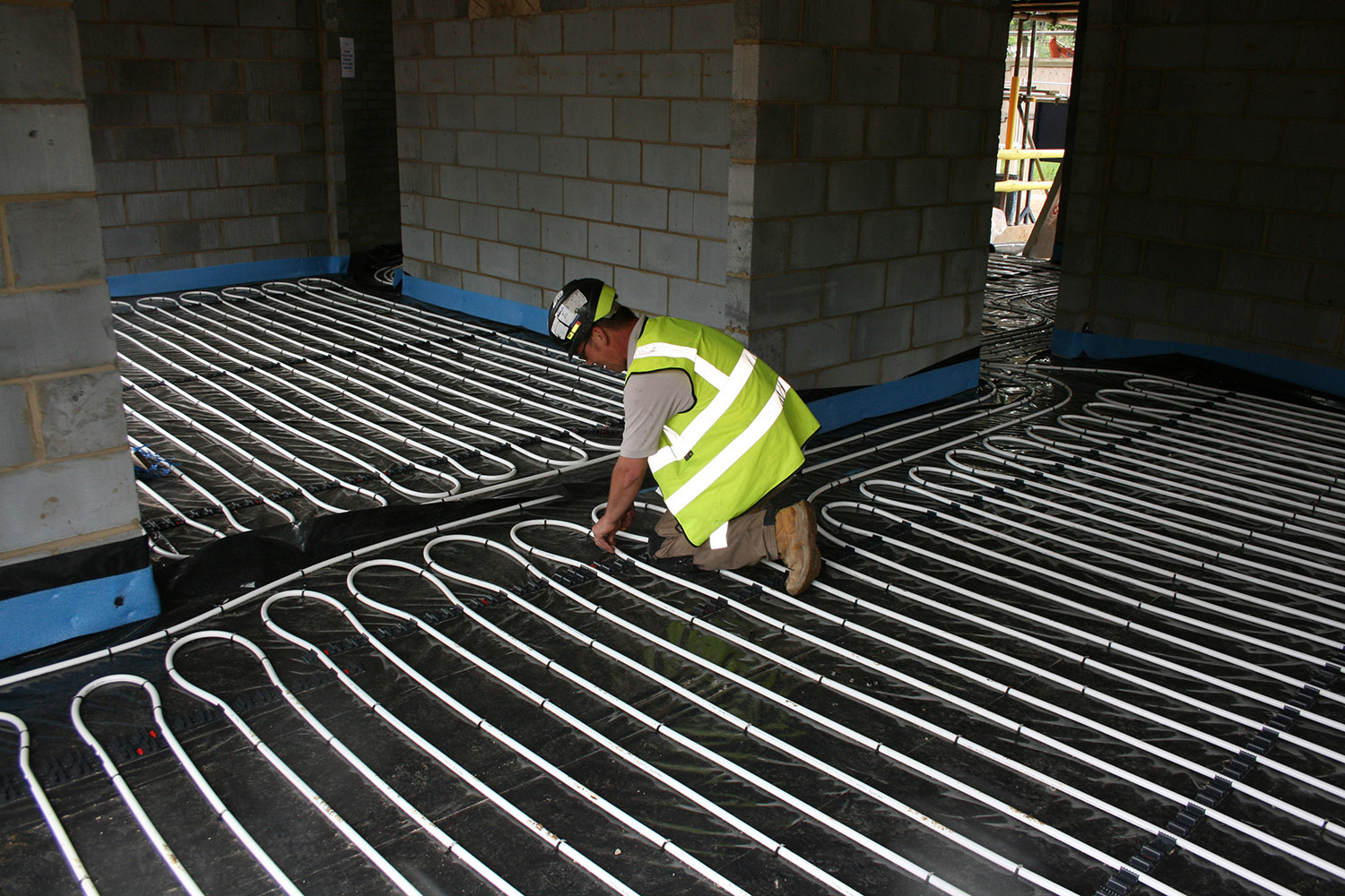 Man Installing underfloor Heating