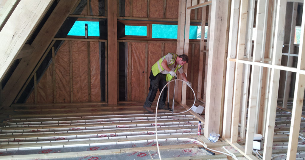 man installing underfloor heating system