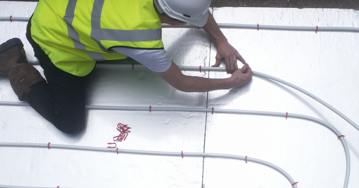 birds eye view man installing ufh