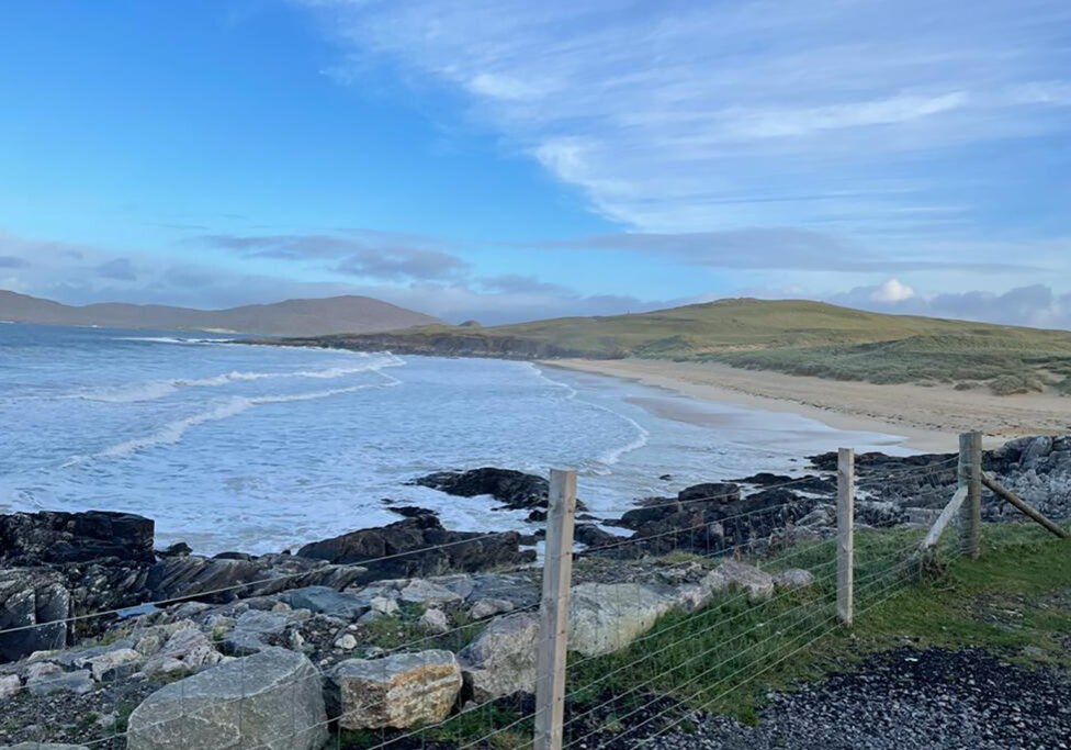 Landscape Photo Of The Sea And A Beach In front Of Hills
